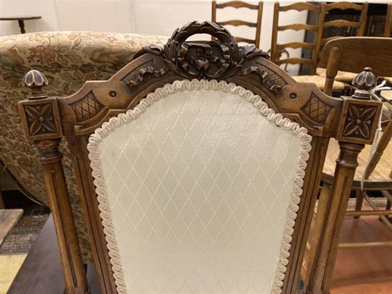 A pair of Victorian carved walnut salon chairs